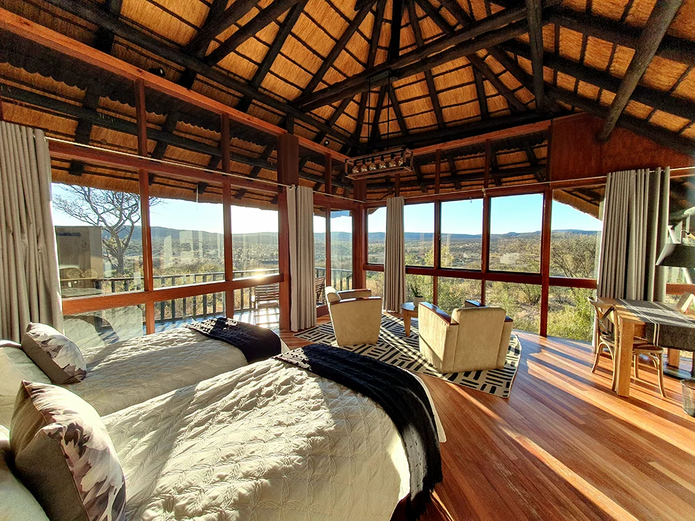 Light-filled chalet suite at GocheGanas featuring king bed and seating area with view.